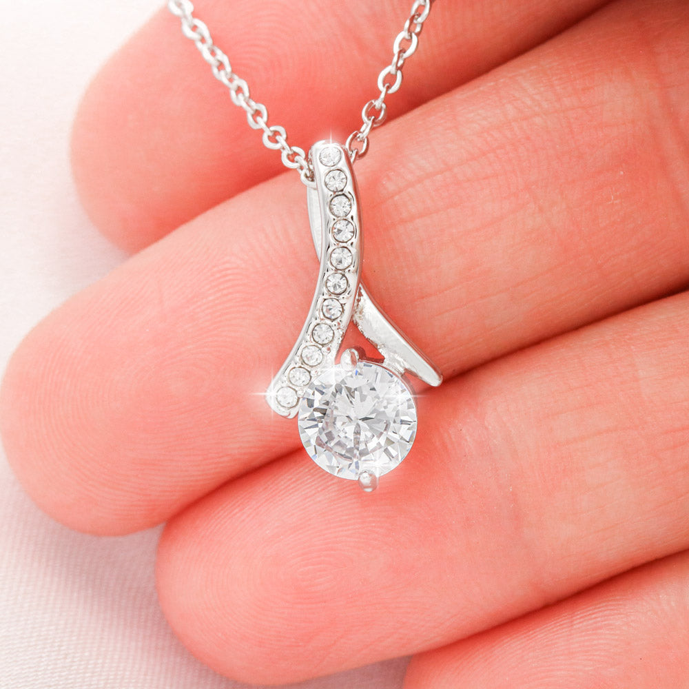 Close-up of a silver-tone heart teardrop pendant necklace with clear stones.