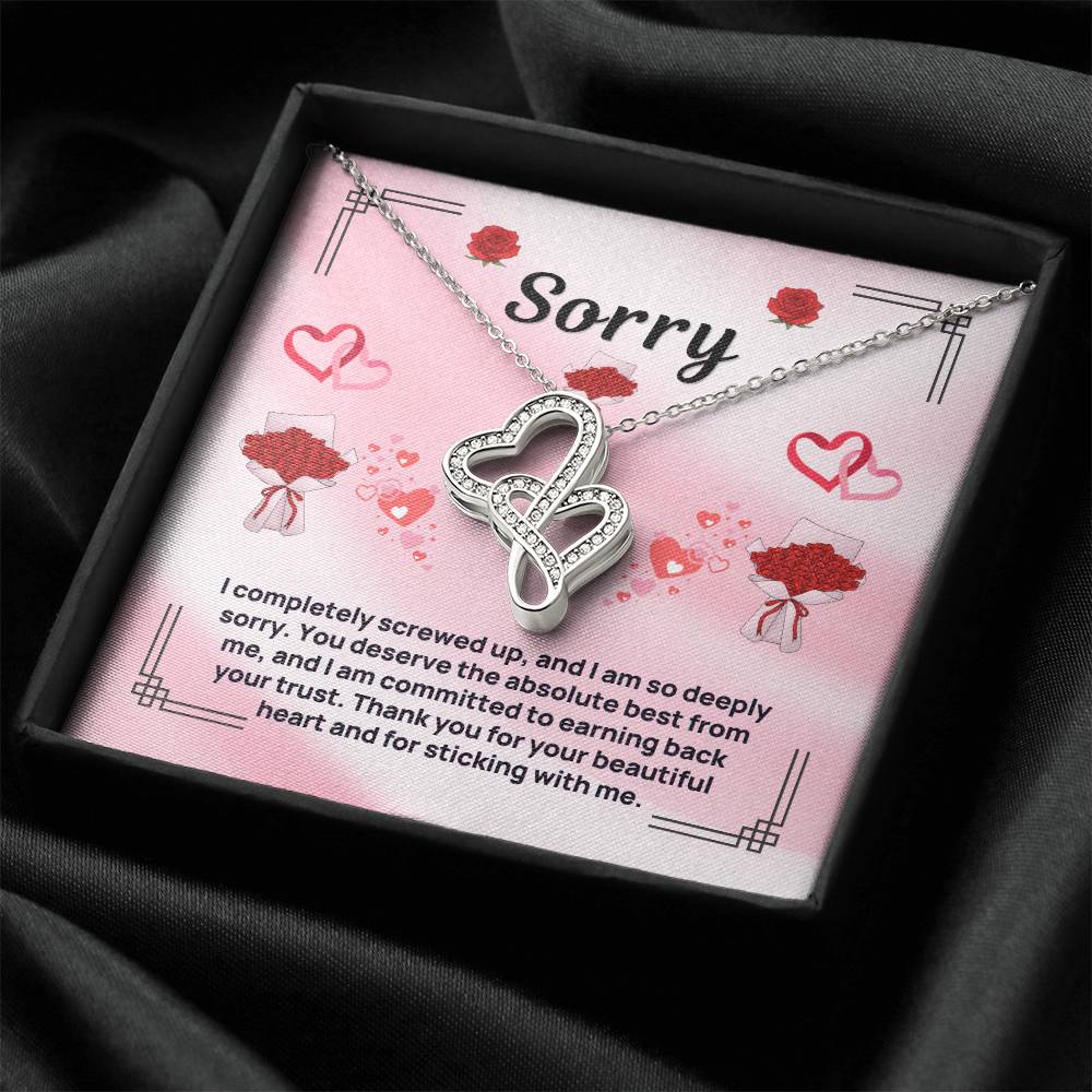 Heart pendant necklace displayed in a dark open gift box with silver-tone chain