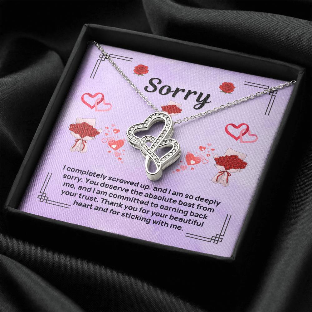 Purple apology card necklace in dark fabric-lined gift box, heart pendant on chain