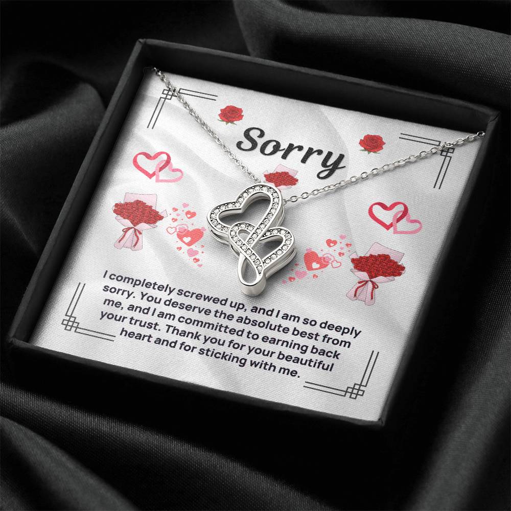 Heart pendant necklace in silver tone, shown in black gift box on dark fabric