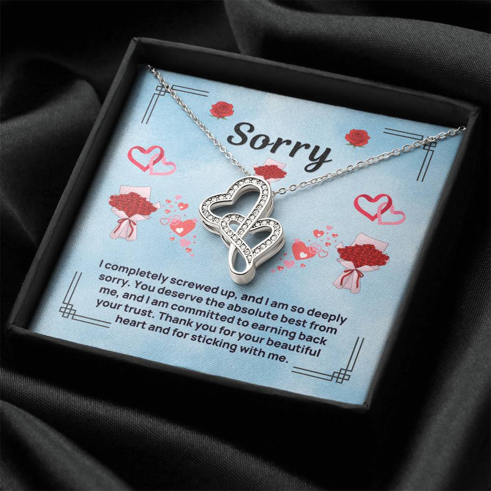 Heart-to-heart necklace with silver-tone heart pendant on blue insert in dark gift box