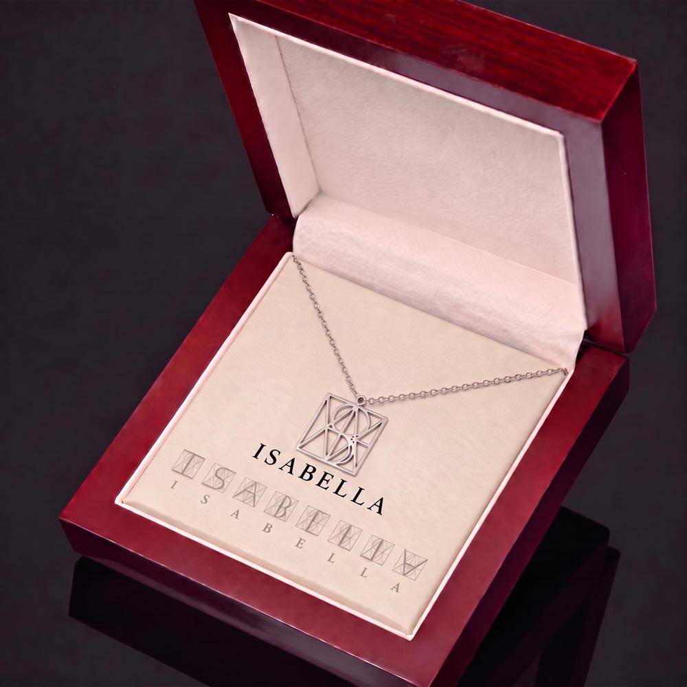 Silver-tone name monogram necklace in open red jewelry gift box