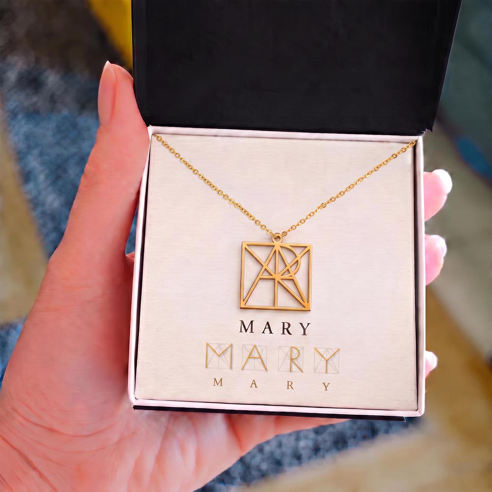 Personalized name monogram necklace with gold-tone pendant in jewelry box