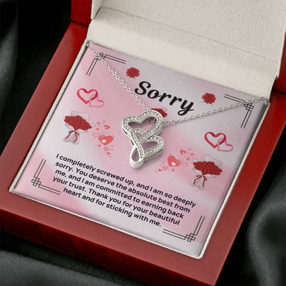 Heart pendant necklace inside open red gift box, silver-tone chain and sparkling heart charm