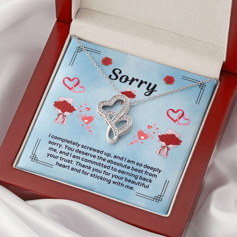Heart-to-heart necklace with silver-tone heart pendant on blue insert in red gift box