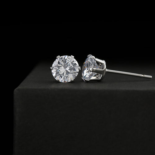 Silver-tone stud earrings with round and marquise cubic zirconia stones, secure backs.