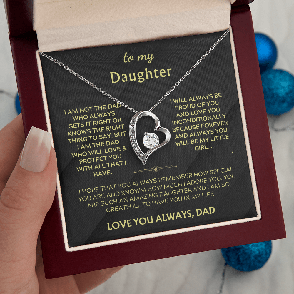 Silver heart pendant necklace on black card inside red gift box, chain visible