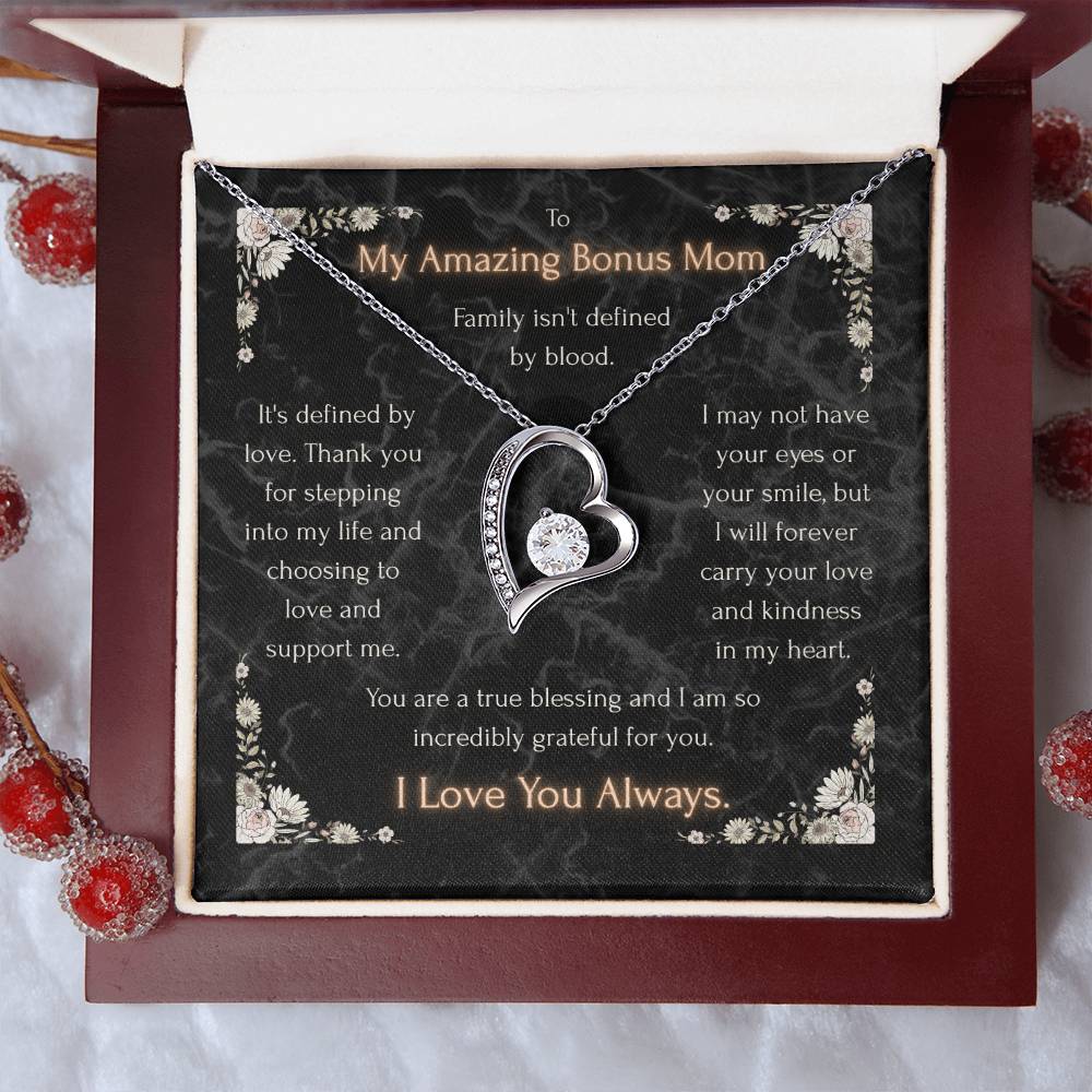 Silver heart pendant necklace with clear stone center on a message card inside a box