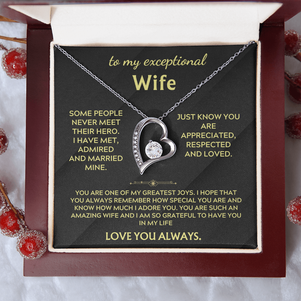 Necklace in open gift box with silver heart pendant and chain on black insert
