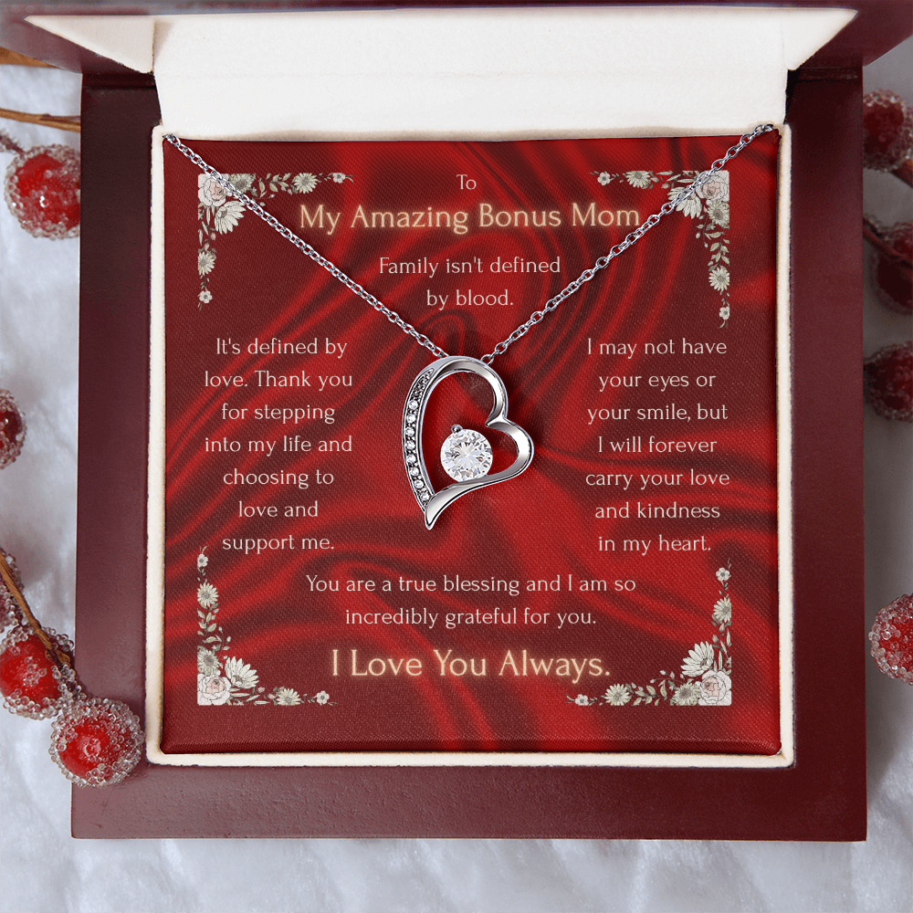 Silver heart pendant necklace over red floral card inside open gift box with white interior.