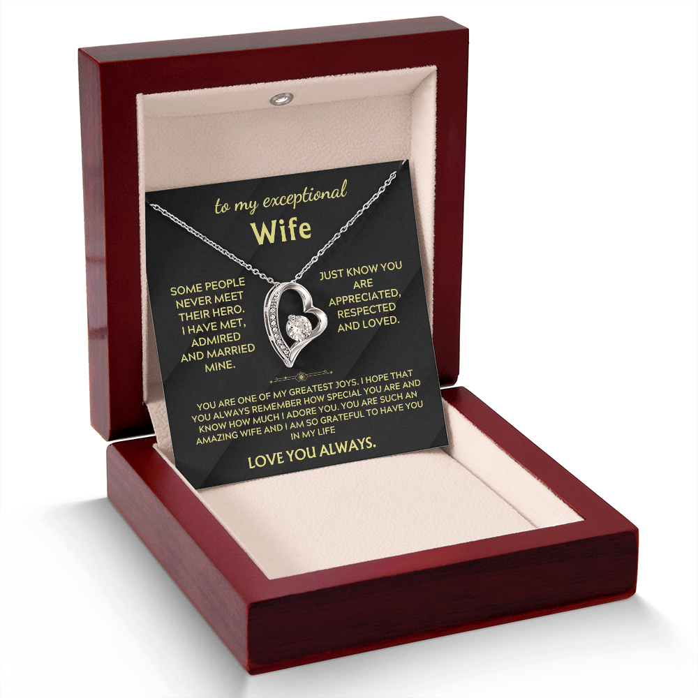 Necklace in open gift box with silver heart pendant and chain over black insert