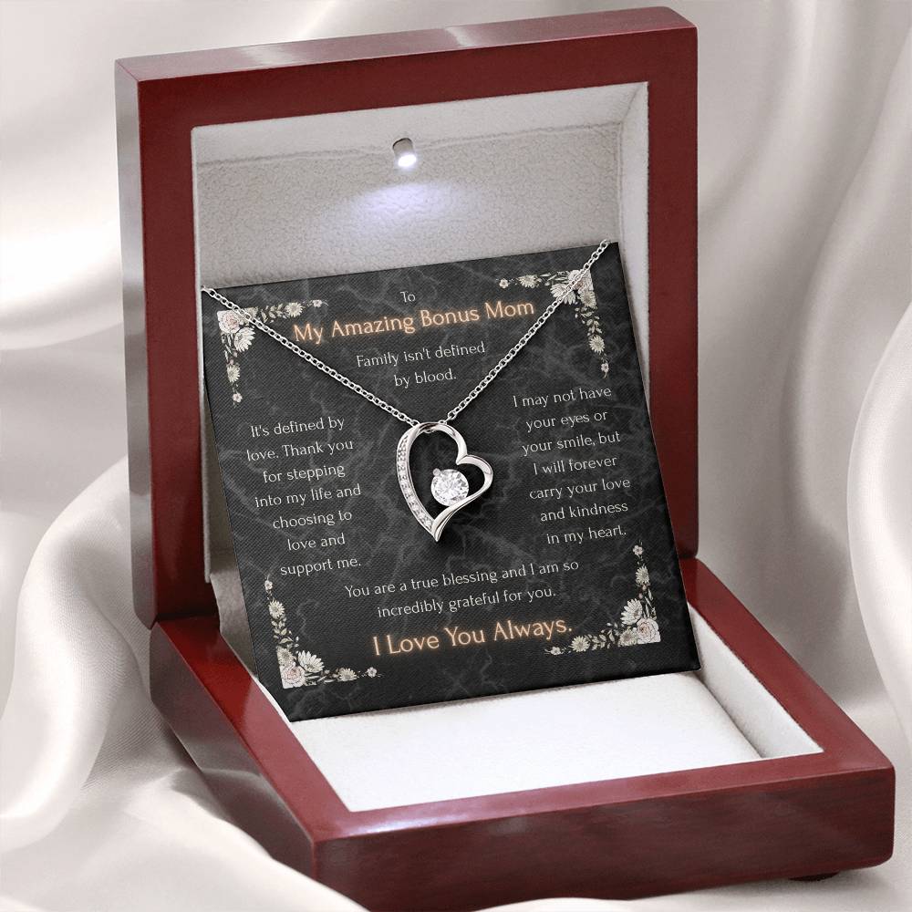 Heart pendant necklace displayed in a maroon box with black message card and silver-tone chain