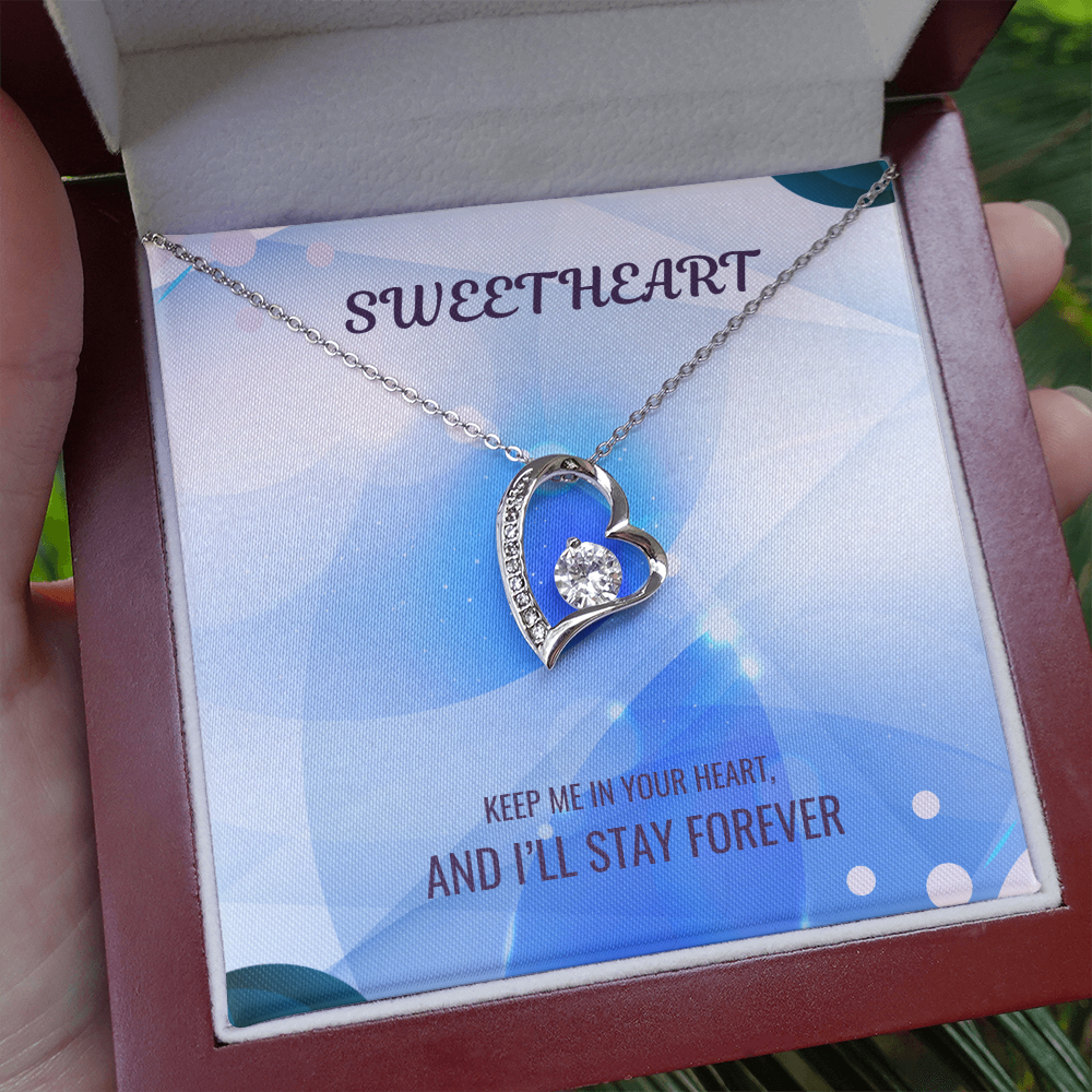 Silver heart pendant necklace displayed in gift box with blue message card