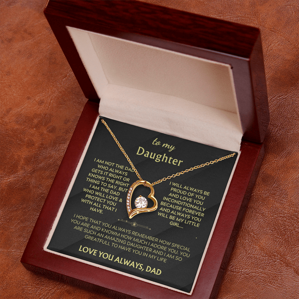 Heart pendant necklace in open gift box, shown from side angle with gold chain