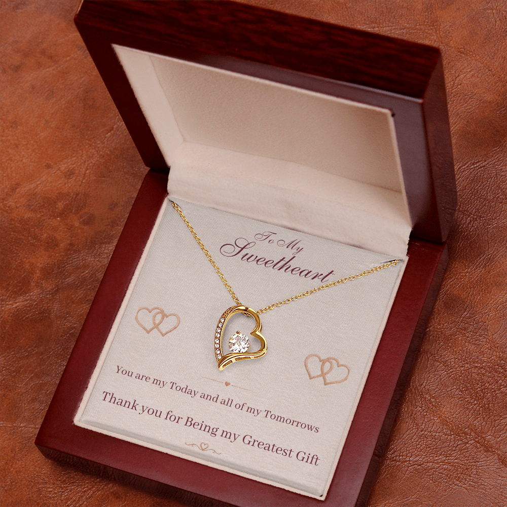 Gold heart pendant necklace in open gift box with sweetheart message card