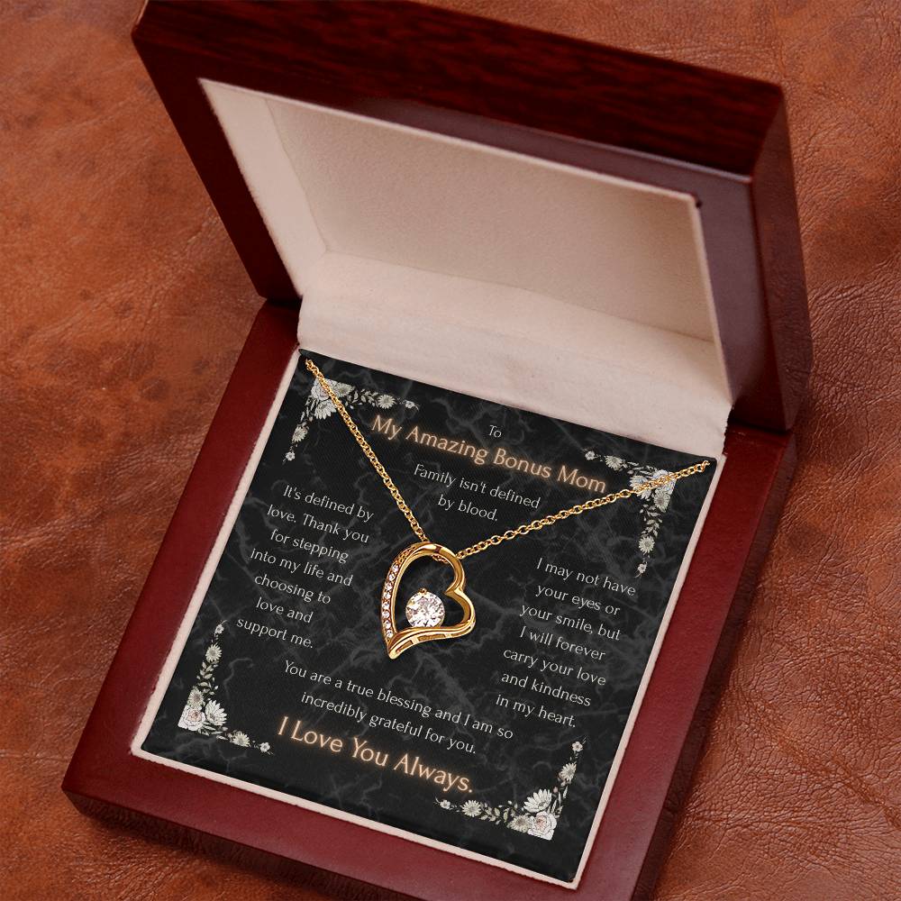 Gold heart pendant necklace with clear stone center on a message card in a gift box