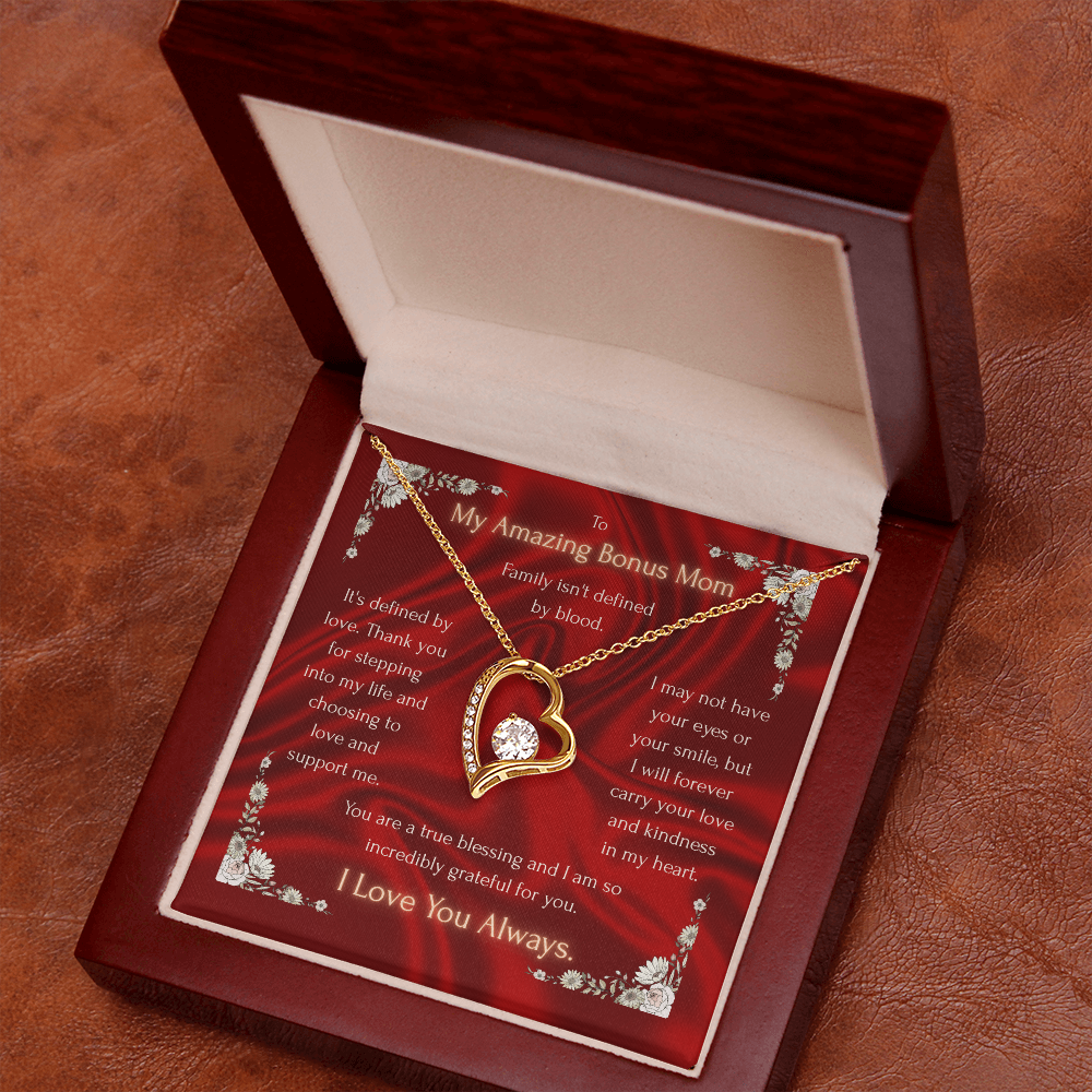 Red gift box with gold-tone heart pendant necklace and chain on a pillow insert