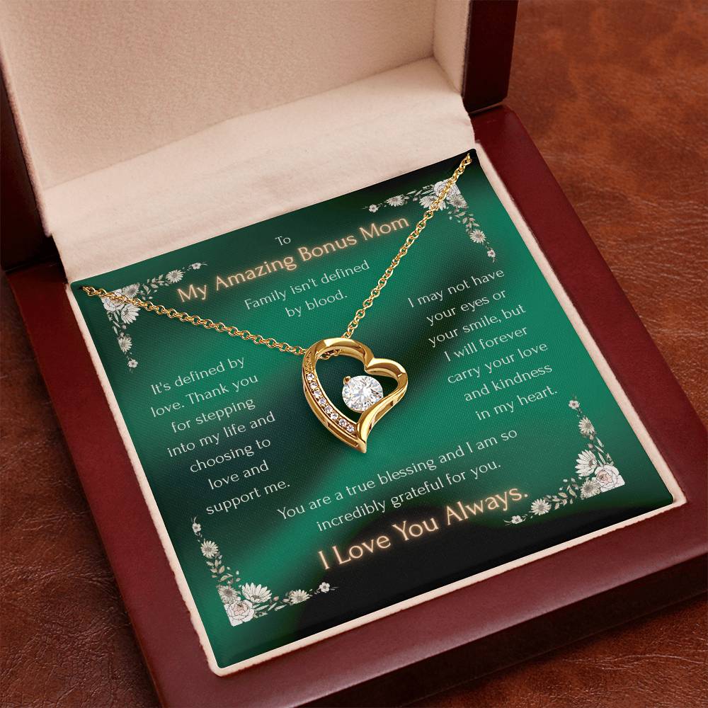 Gold heart pendant necklace with crystal inset and chain, in an open gift box