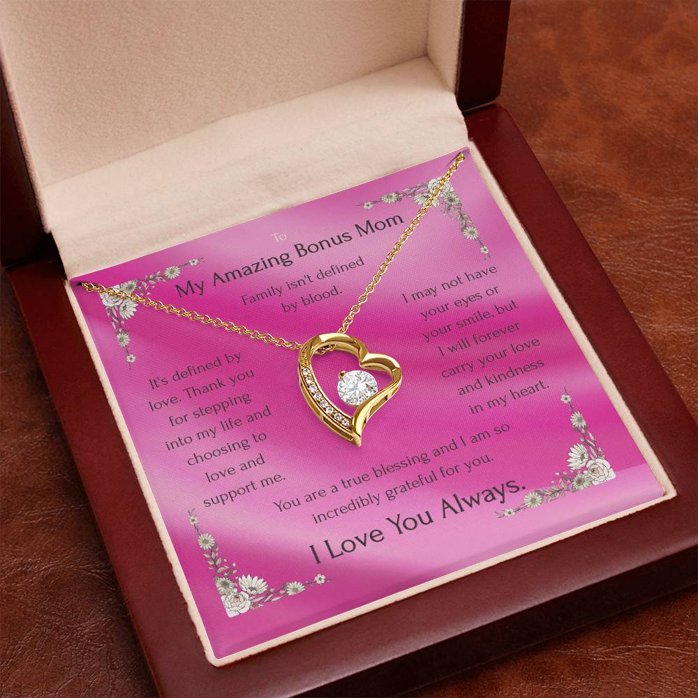 Gold heart pendant necklace on pink message card inside an open gift box