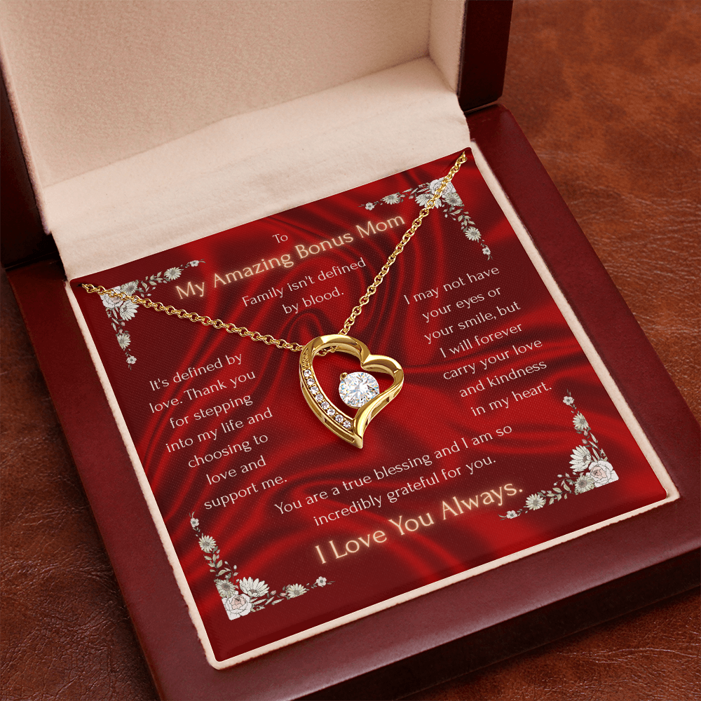 Red gift box insert with gold-tone heart pendant necklace over printed message card