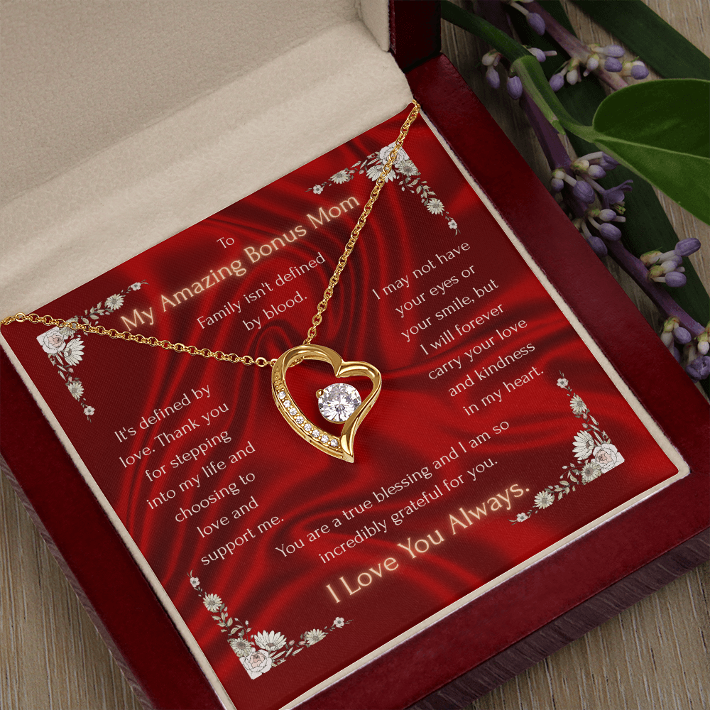 Red keepsake necklace with gold heart pendant and clear stones inside a red box