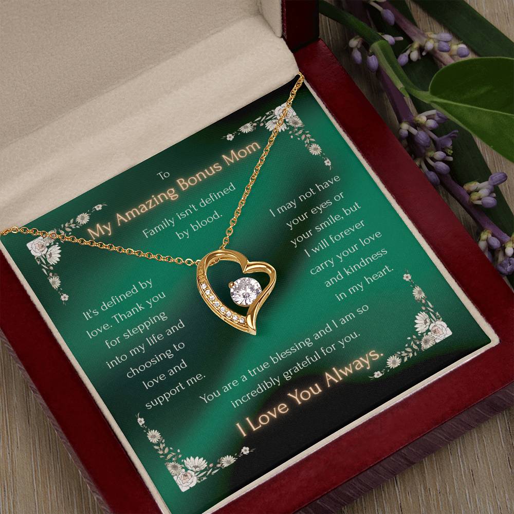 Heart pendant necklace on a green message card inside a gift box on wood surface