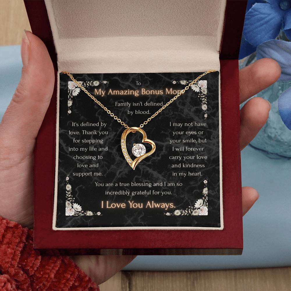 Gold heart pendant necklace with clear stone center on a message card in a gift box