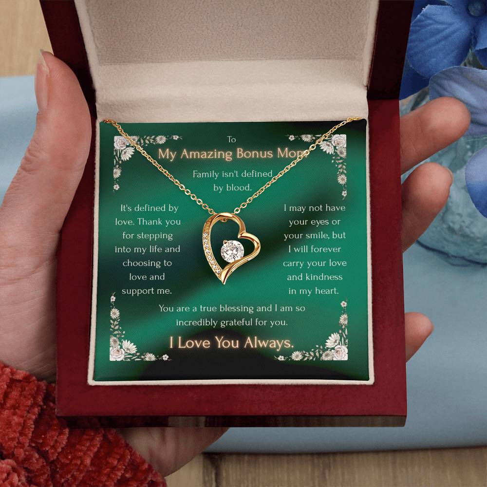 Gold heart pendant necklace with crystal accents, held open in a gift box