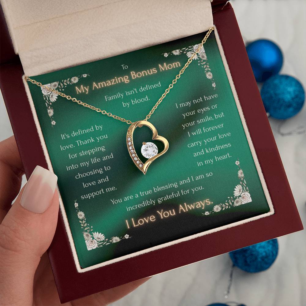 Heart pendant necklace on green message card inside a gift box held in hand