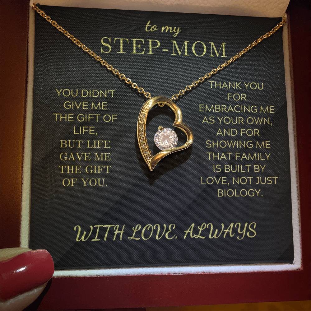 Heart pendant necklace on black gift card inside box, gold tone