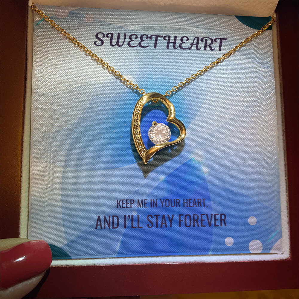 Gold heart pendant necklace in gift box with blue sentimental message card