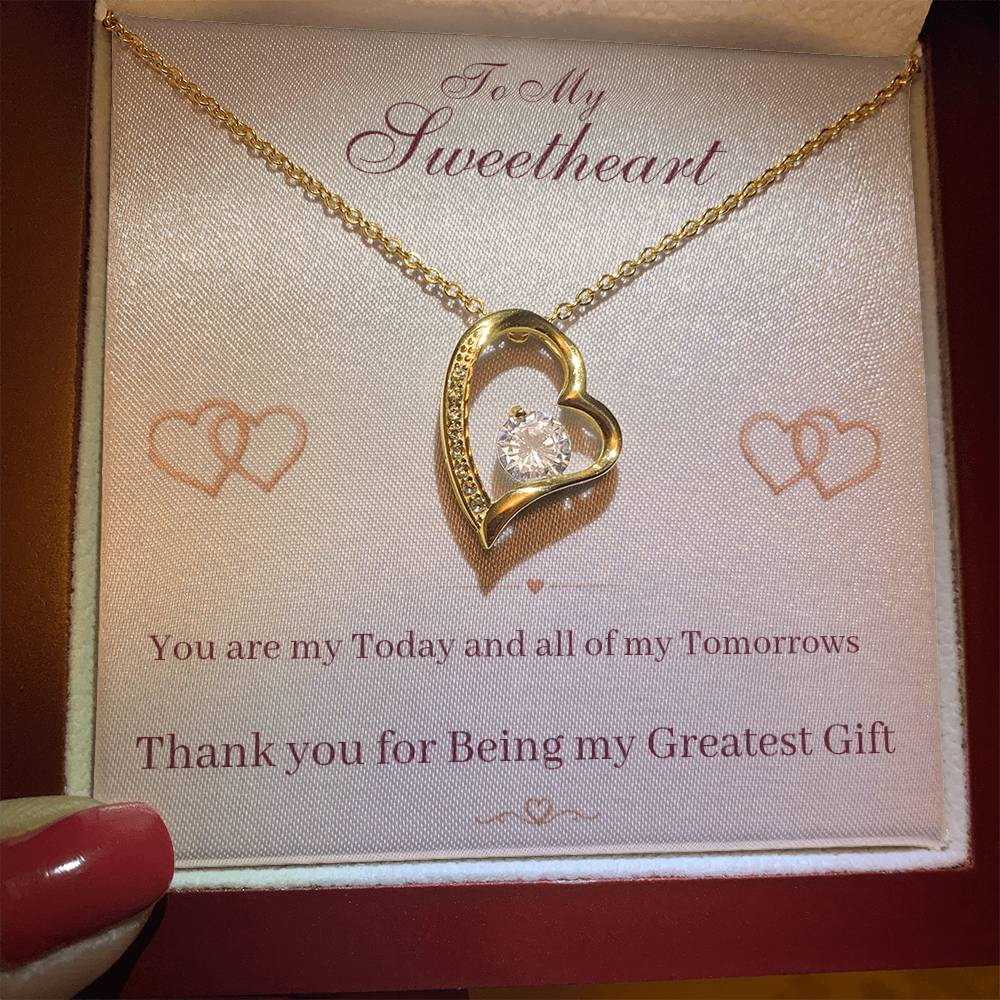Heart pendant necklace with gold-tone chain, heart bezel with center sparkle stone