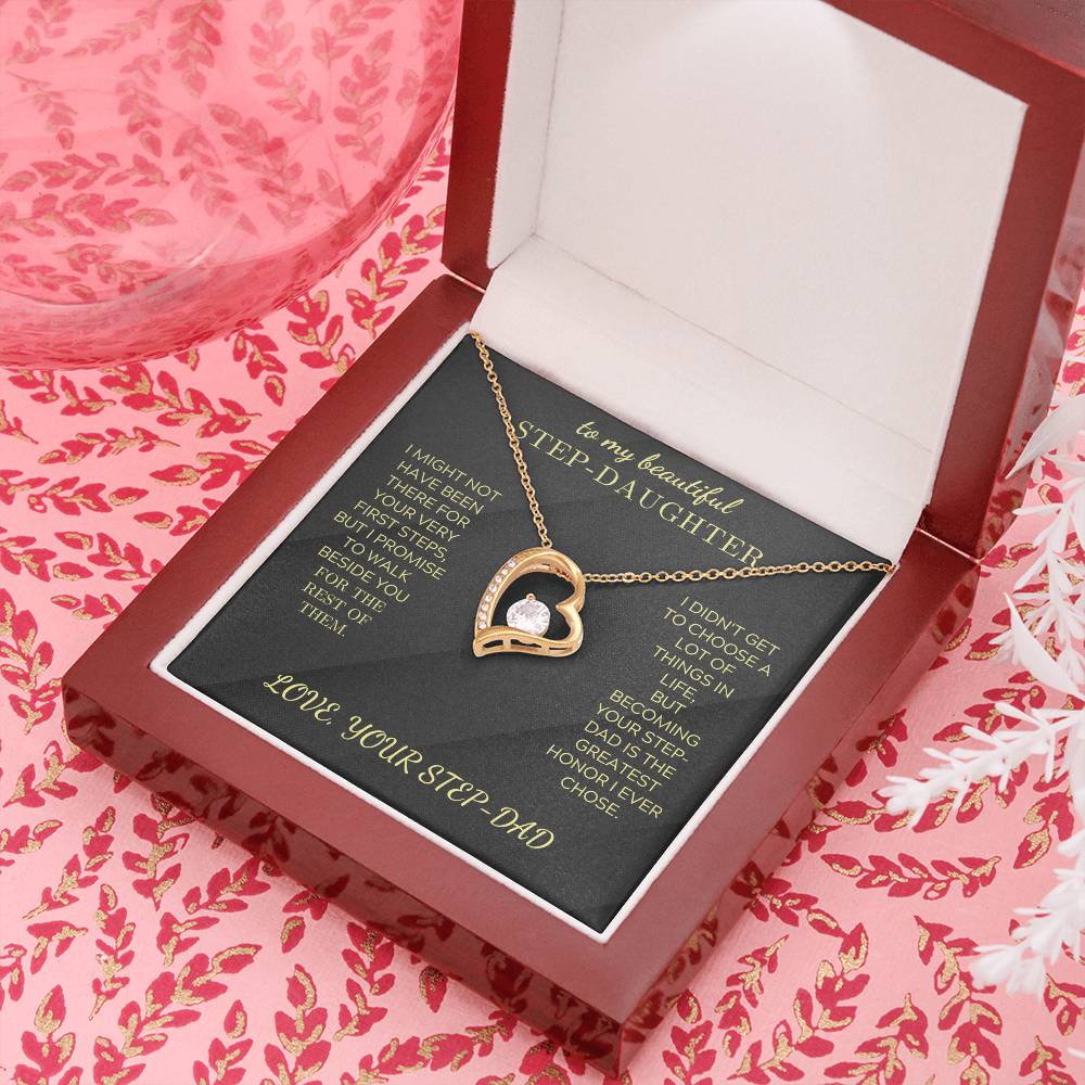 Heart pendant necklace with gold-tone chain and clear stone, resting in open box