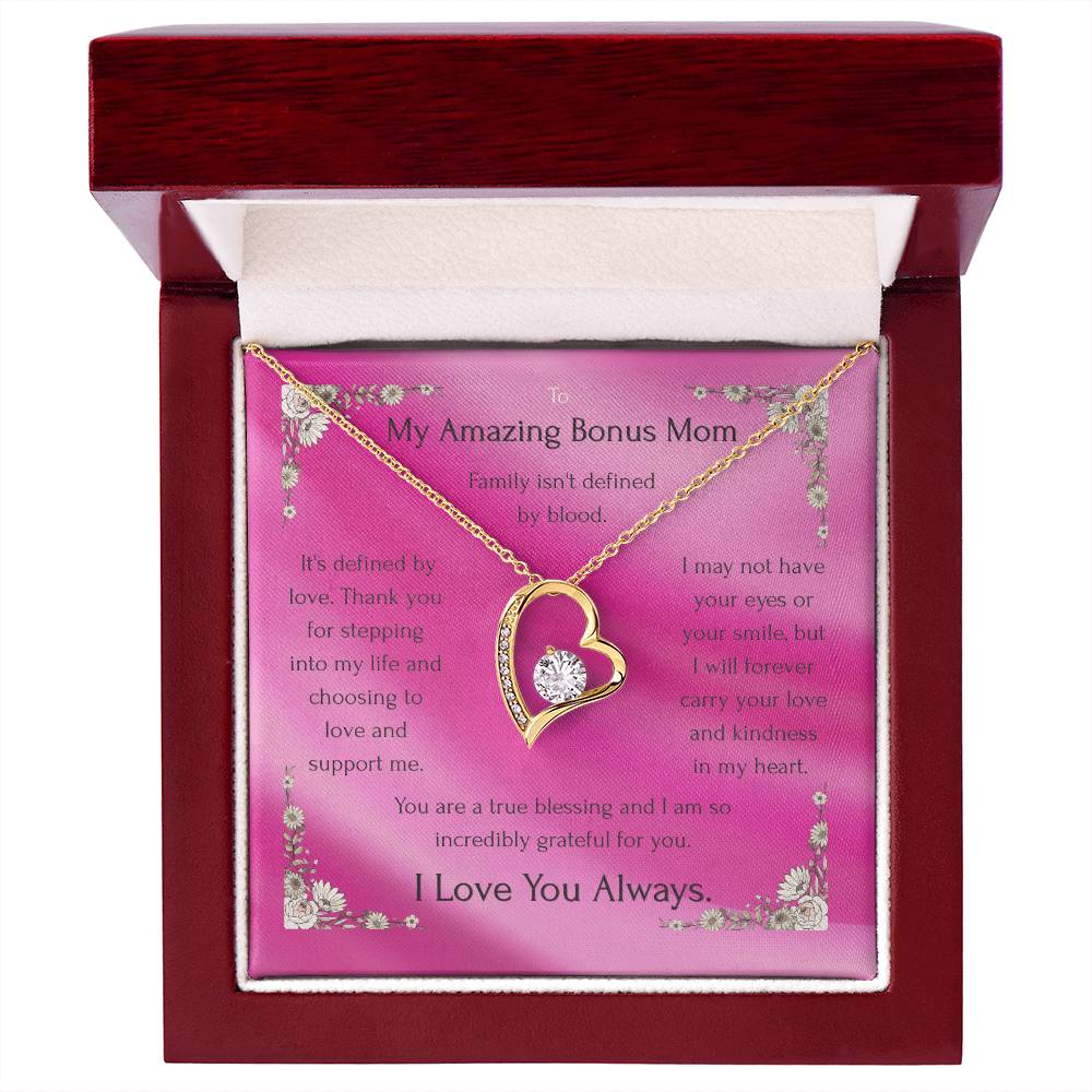 Gold heart pendant necklace on pink message card inside a red gift box