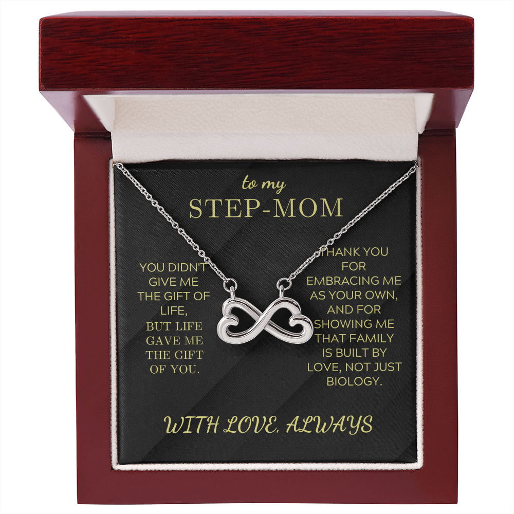 Silver infinity heart pendant necklace on black card inside a red gift box