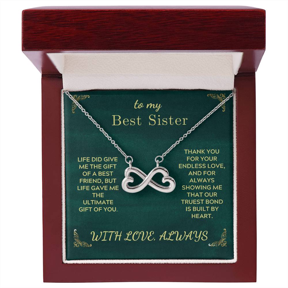 Gold-tone infinity heart sister necklace inside maroon gift box