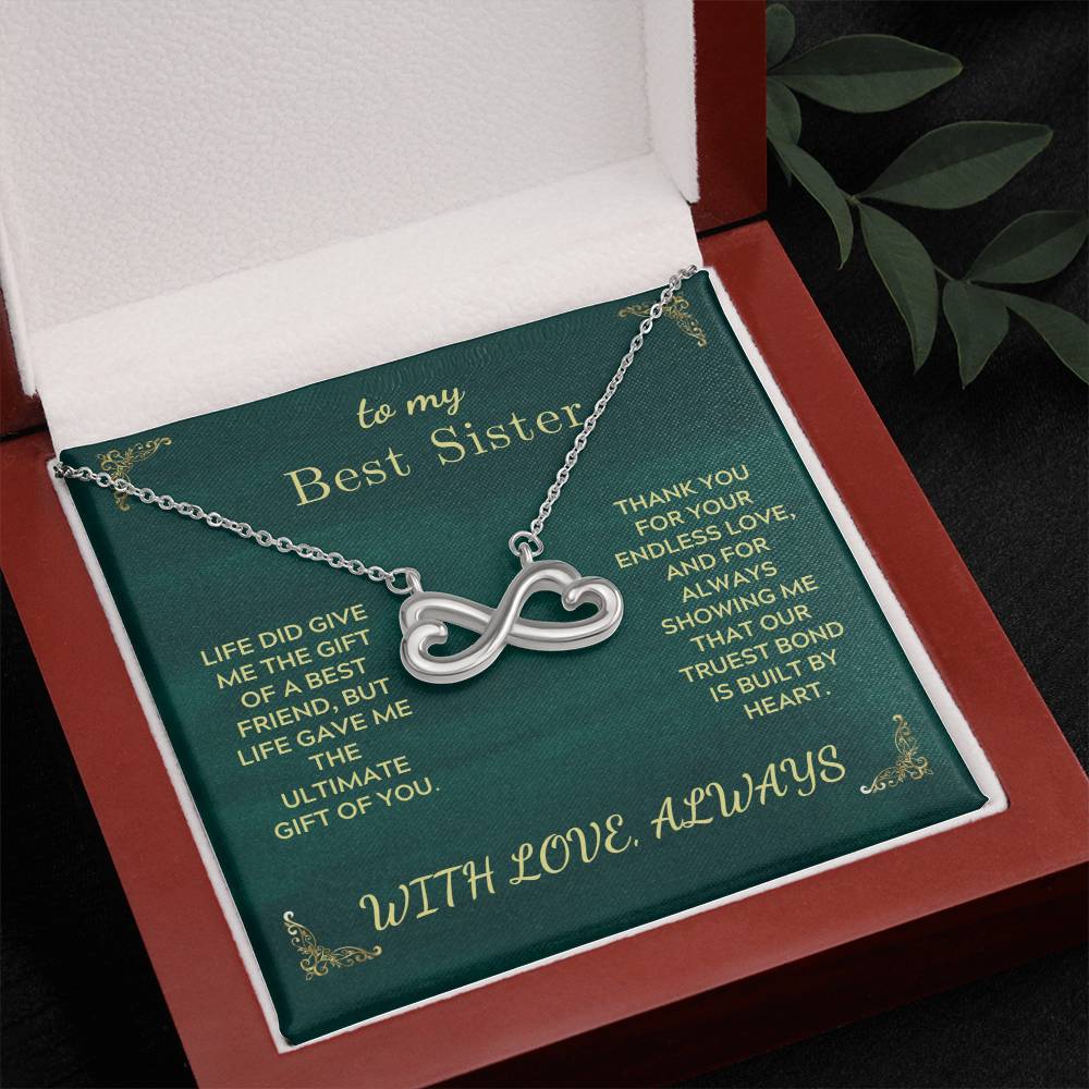 Silver-tone infinity heart sister necklace in green gift box with open lid
