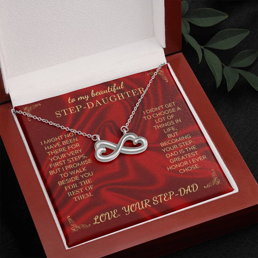 Red gift box insert showing a silver heart-infinity pendant on a necklace chain