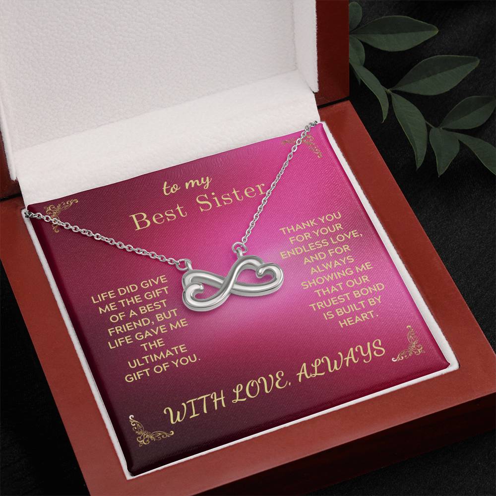 Silver-tone infinity heart pendant necklace on rose card inside open gift box