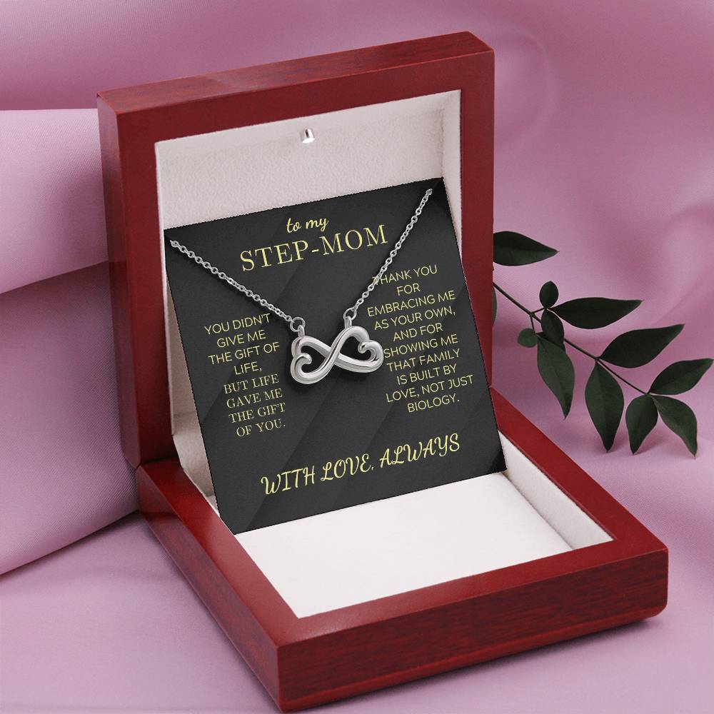 Open gift box with black “STEP-MOM” card and silver infinity heart necklace