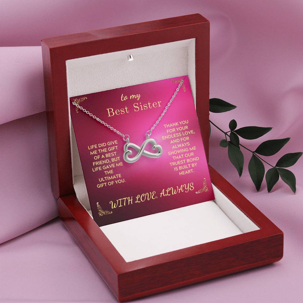 Infinity-heart necklace displayed in a red gift box