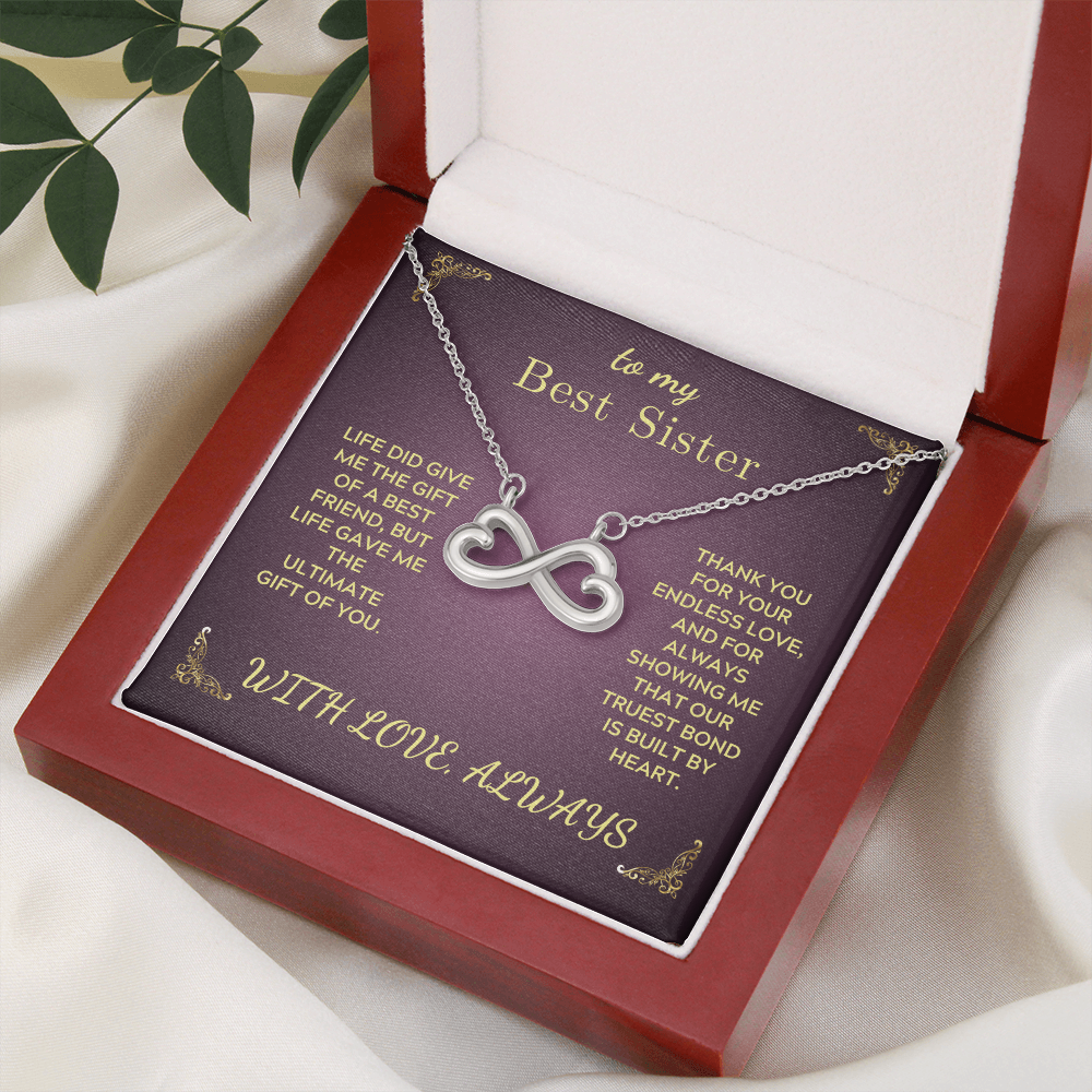 Infinity heart pendant necklace on purple gift card in open box, silver-tone chain
