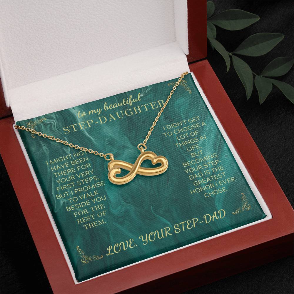 Gold heart infinity pendant necklace on green message card in an open red gift box