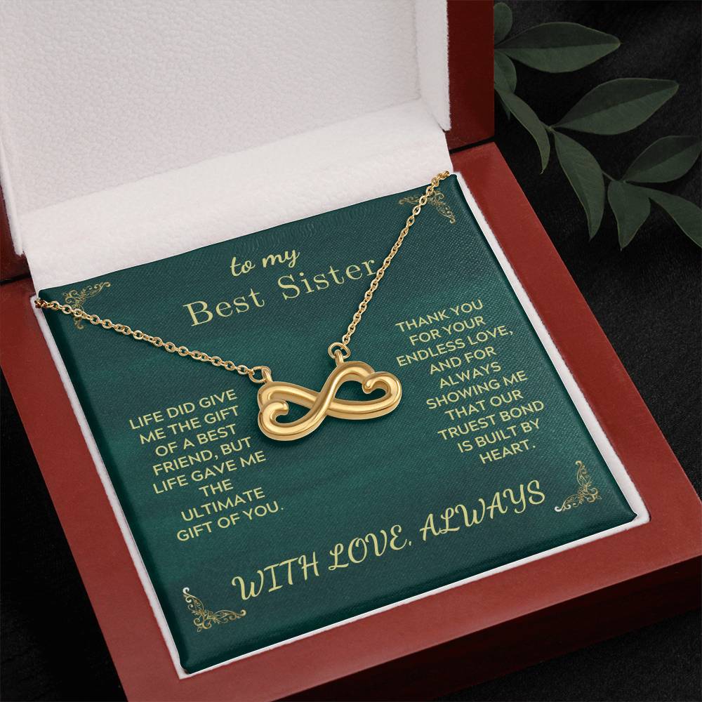 Gold-tone infinity heart sister necklace in green gift box with open lid