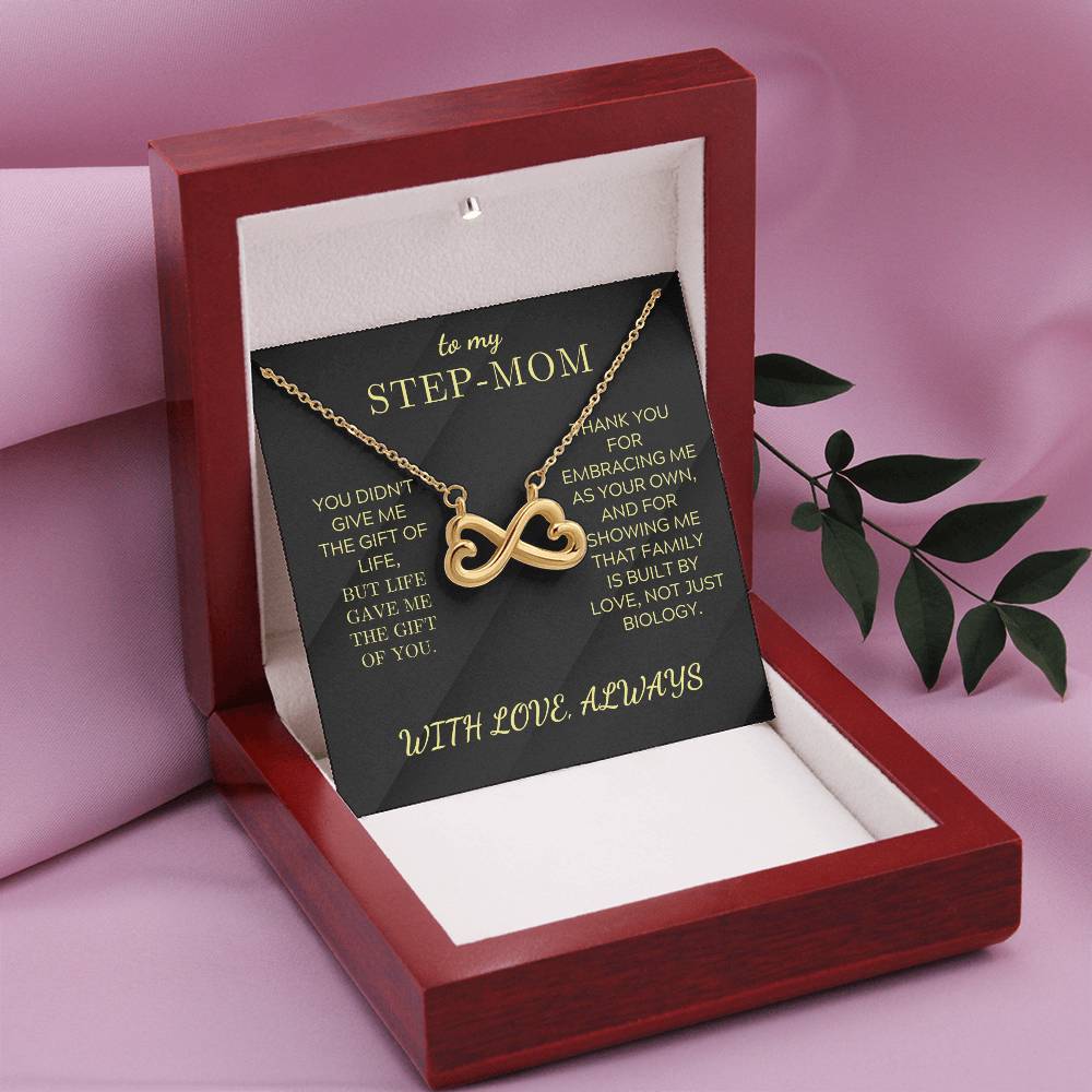 Open red gift box with black “STEP-MOM” card and gold infinity heart necklace