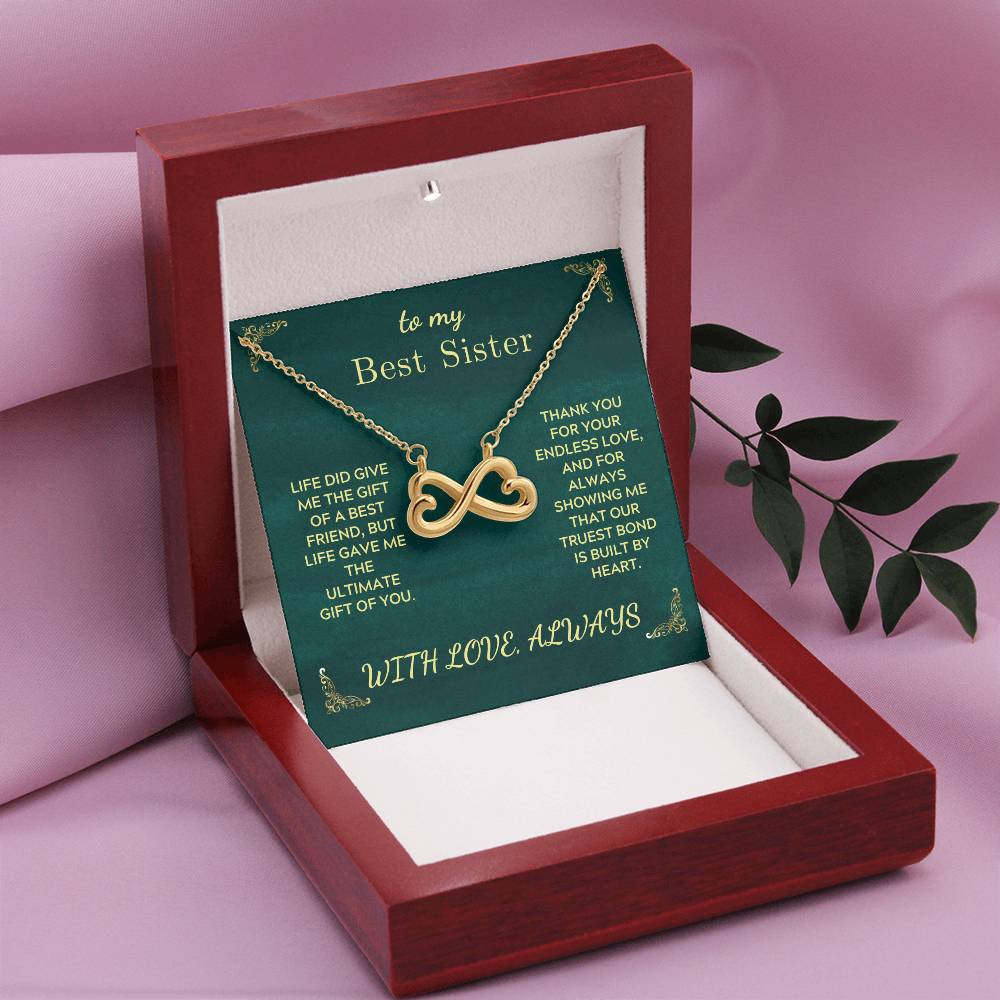 Open gift box with infinity heart pendant necklace on green card insert