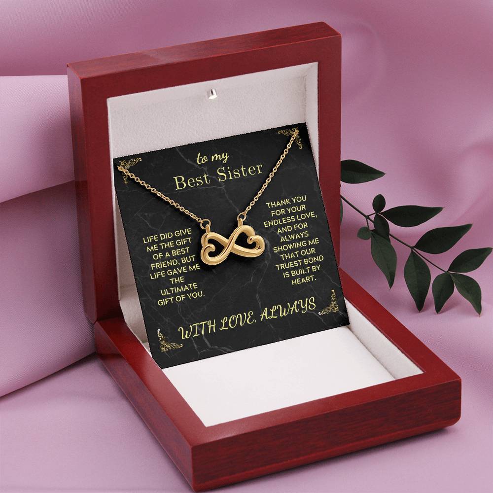 Gold infinity heart pendant necklace in open red gift box with black message card