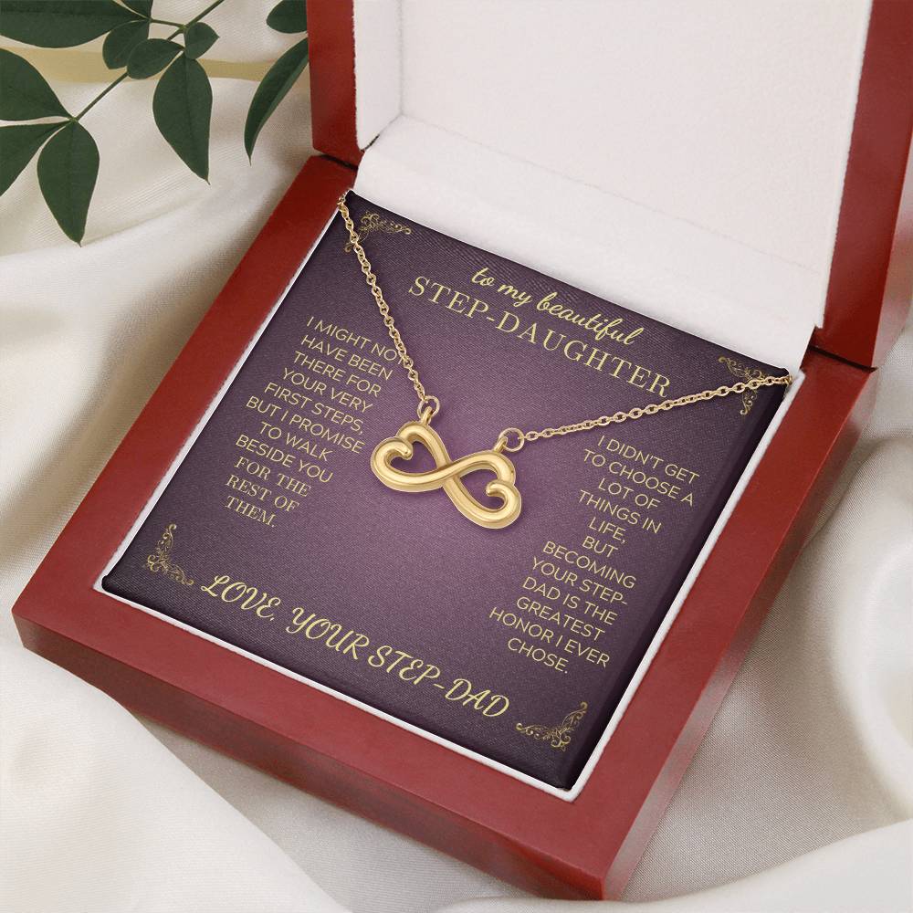 Gold infinity heart pendant necklace on purple card inside open gift box