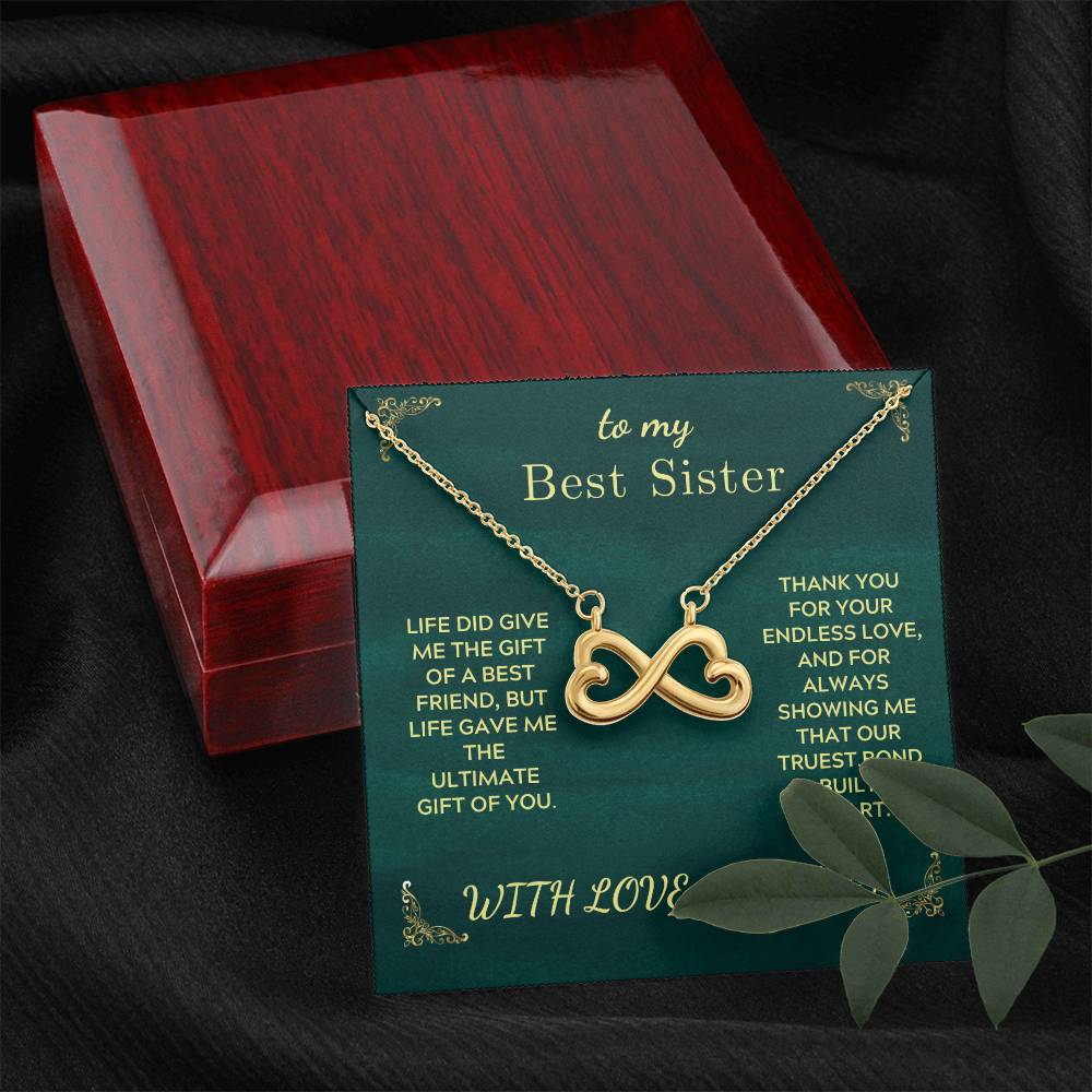 Infinity heart pendant necklace on green card inside red wooden gift box