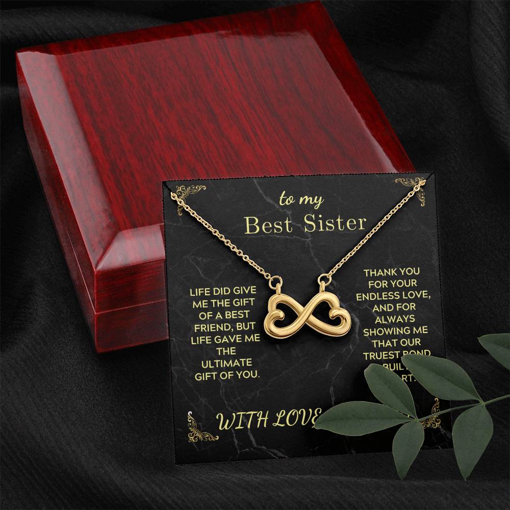 Gold infinity heart pendant necklace on black card in red wooden gift box